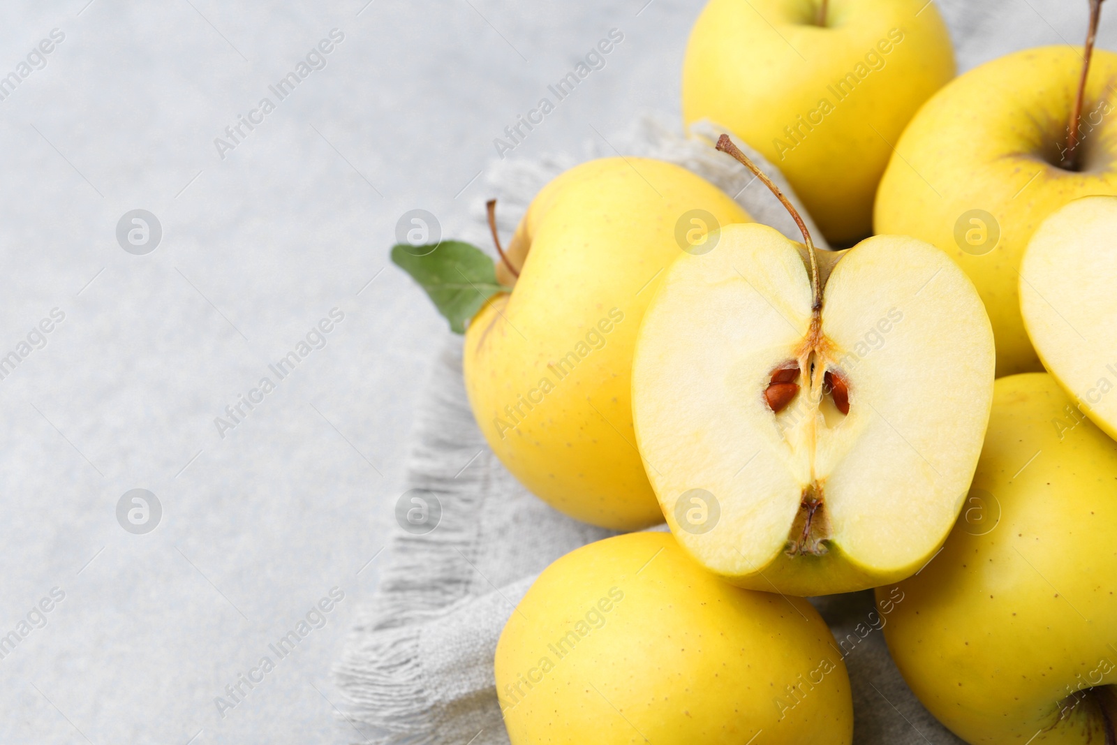 Photo of Fresh ripe yellow apples on grey table, closeup. Space for text