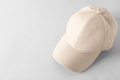 Photo of Stylish baseball cap on light grey background. Mockup for design