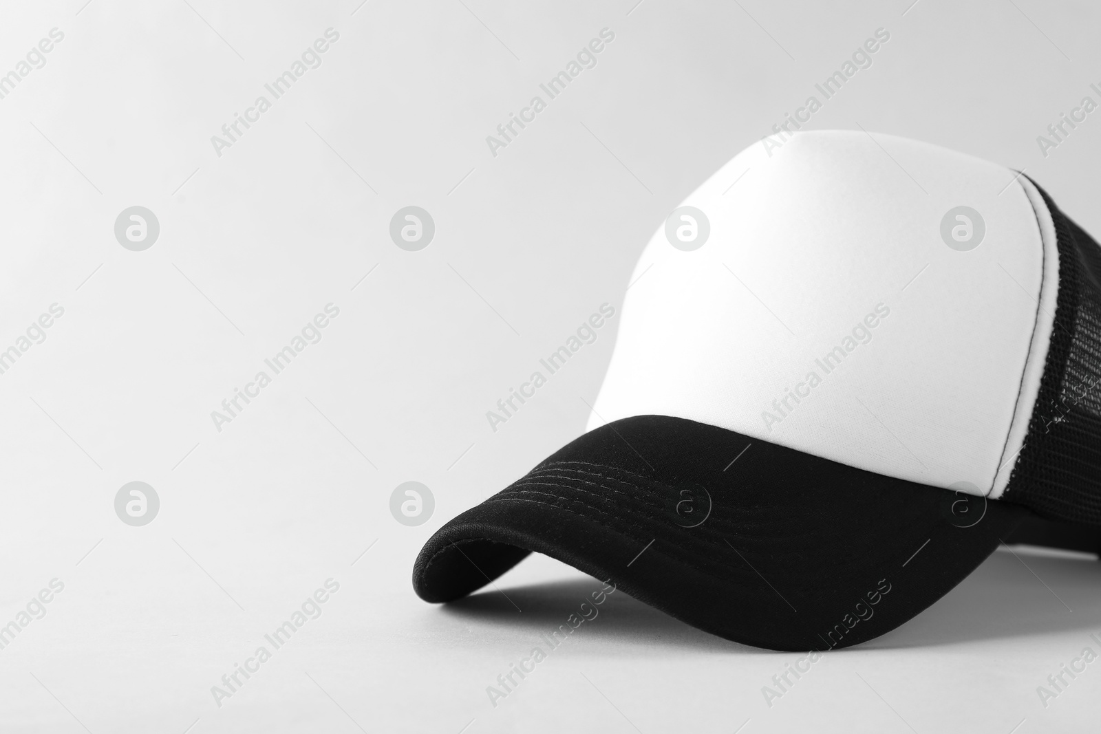 Photo of Stylish baseball cap on light grey background, closeup. Mockup for design