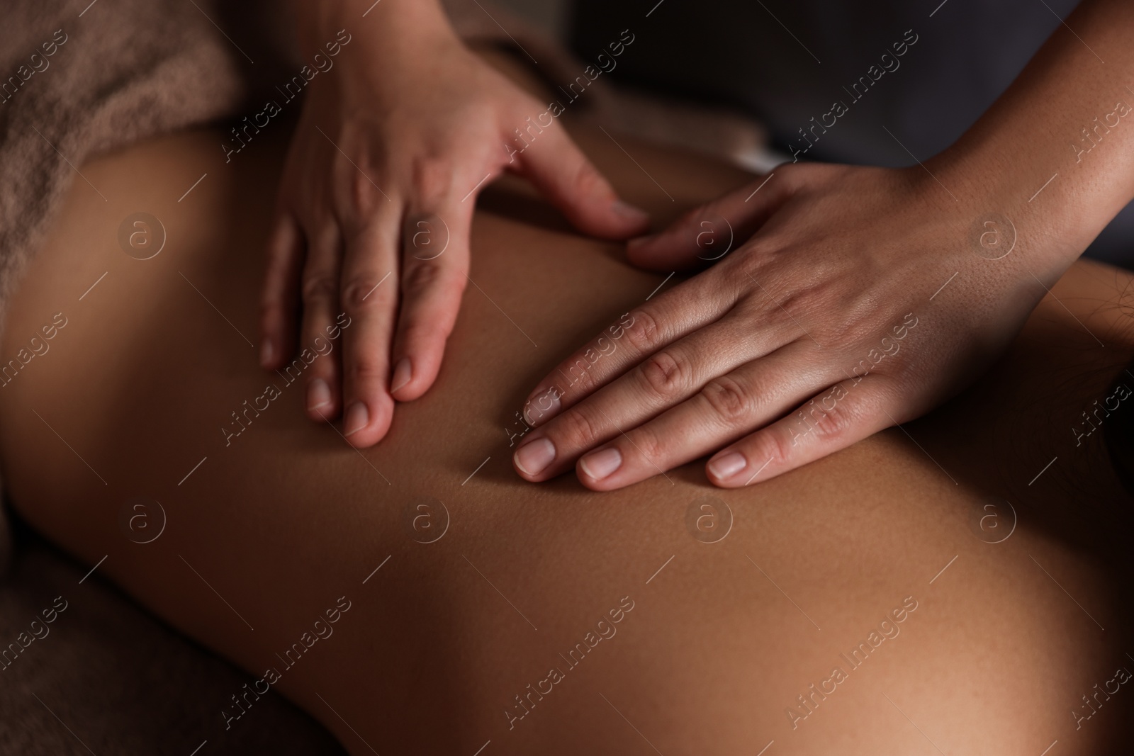 Photo of Woman receiving back massage in spa salon, closeup