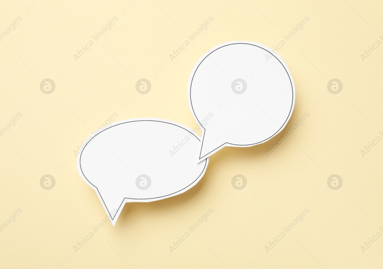 Photo of Blank speech bubbles on beige background, top view. Space for text