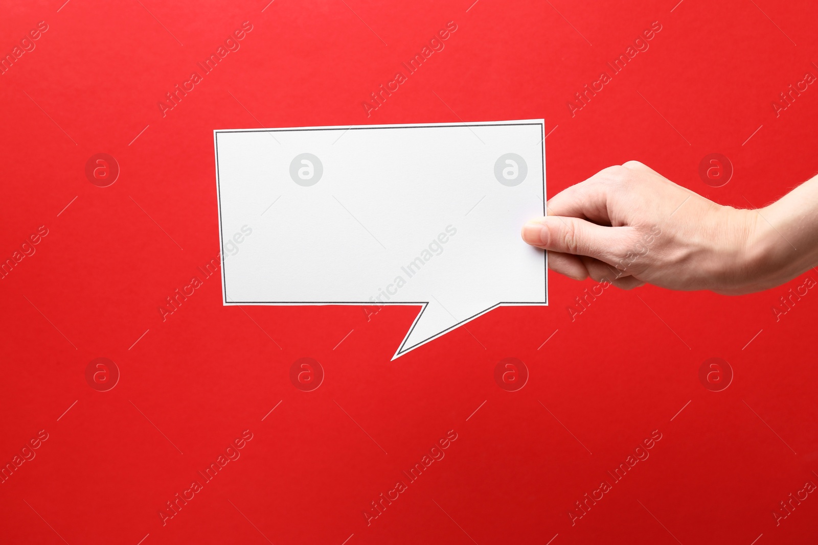 Photo of Woman holding blank speech bubble on red background, closeup. Space for text