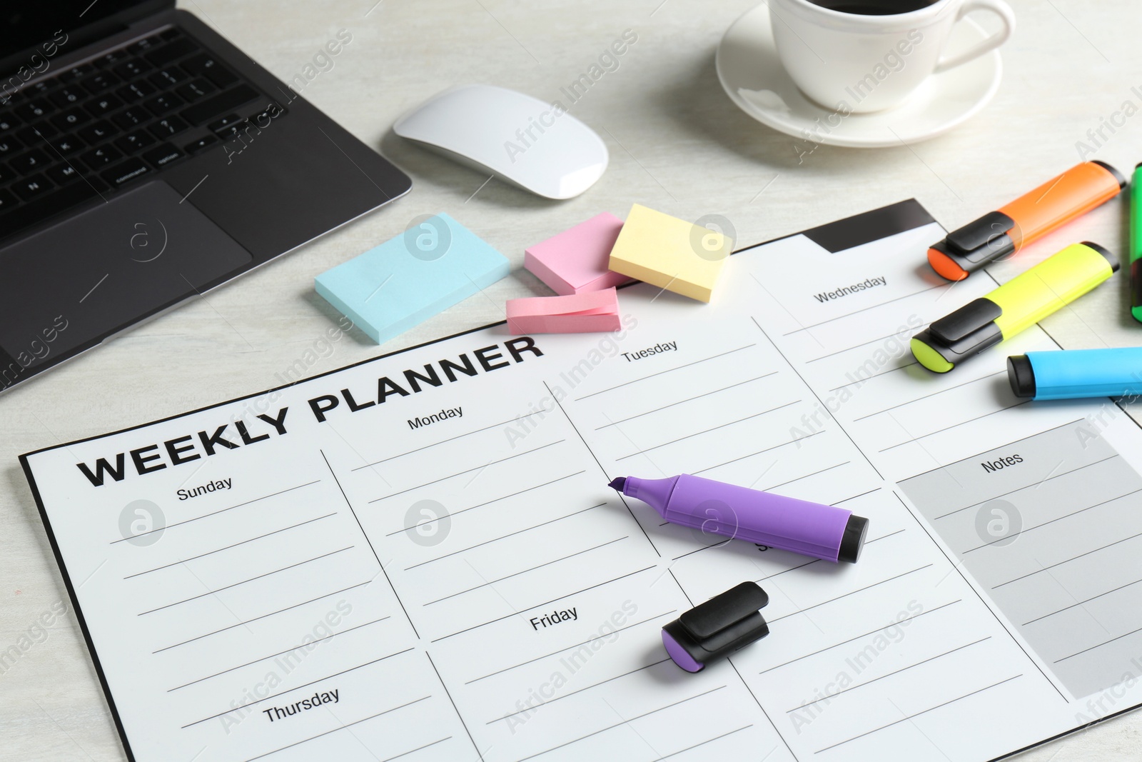 Photo of Timetable. Weekly planner, stationery, laptop and coffee on white table, closeup