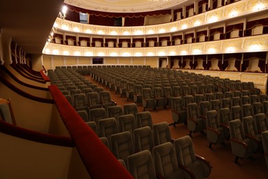 Photo of Rows of gray comfortable seats in theatre