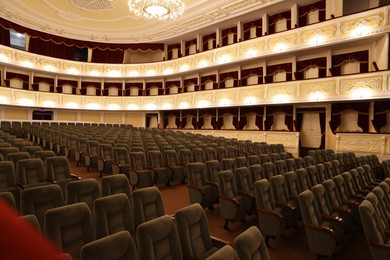 Photo of Rows of gray comfortable seats in theatre