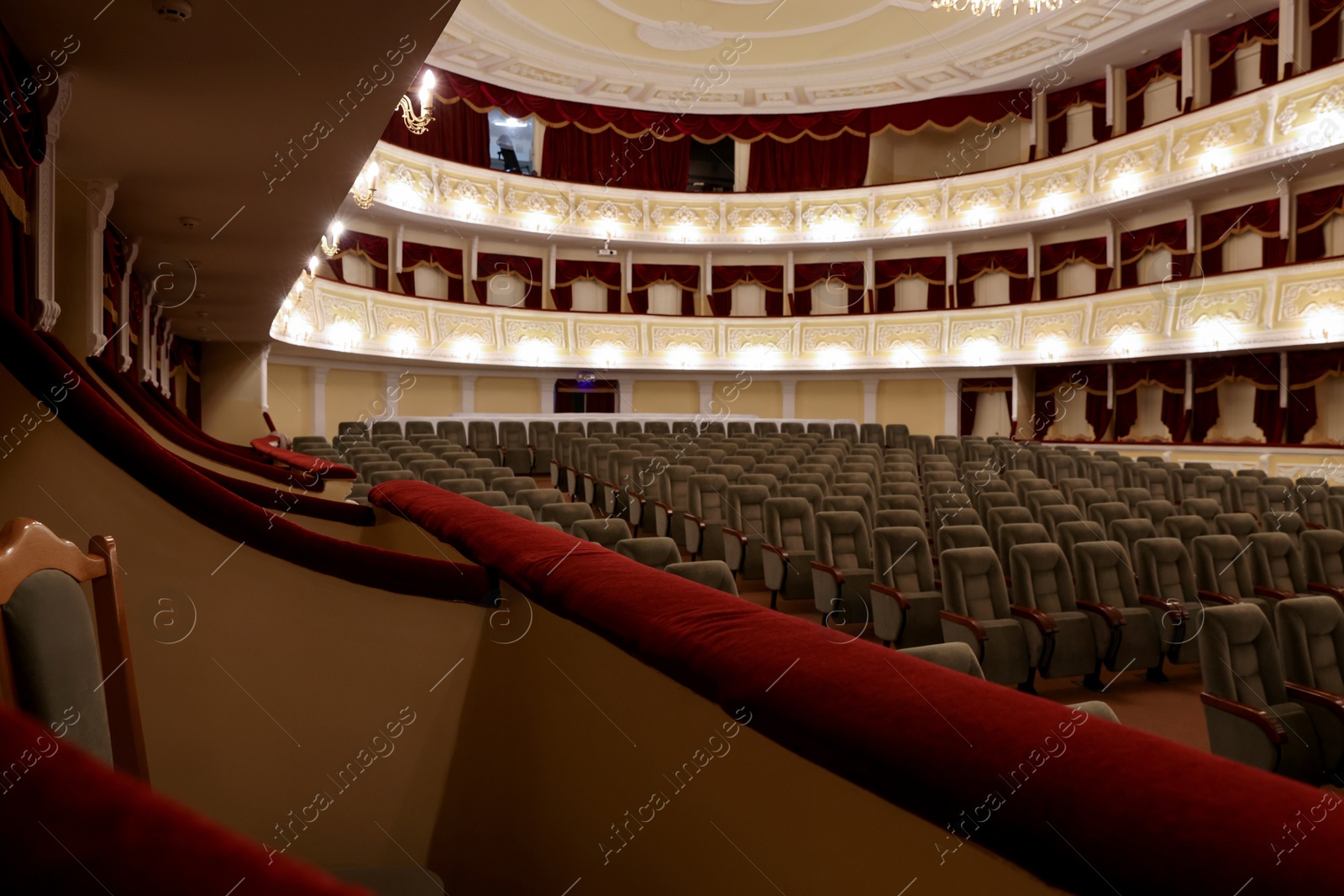 Photo of Rows of gray comfortable seats in theatre