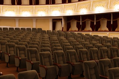 Photo of Rows of gray comfortable seats in theatre