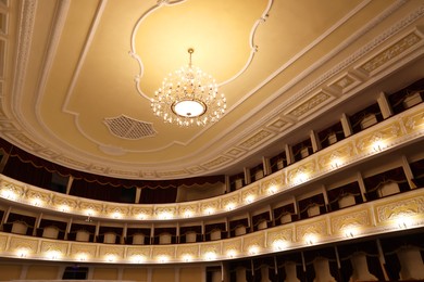 Stylish vintage chandelier in theatre, low angle view