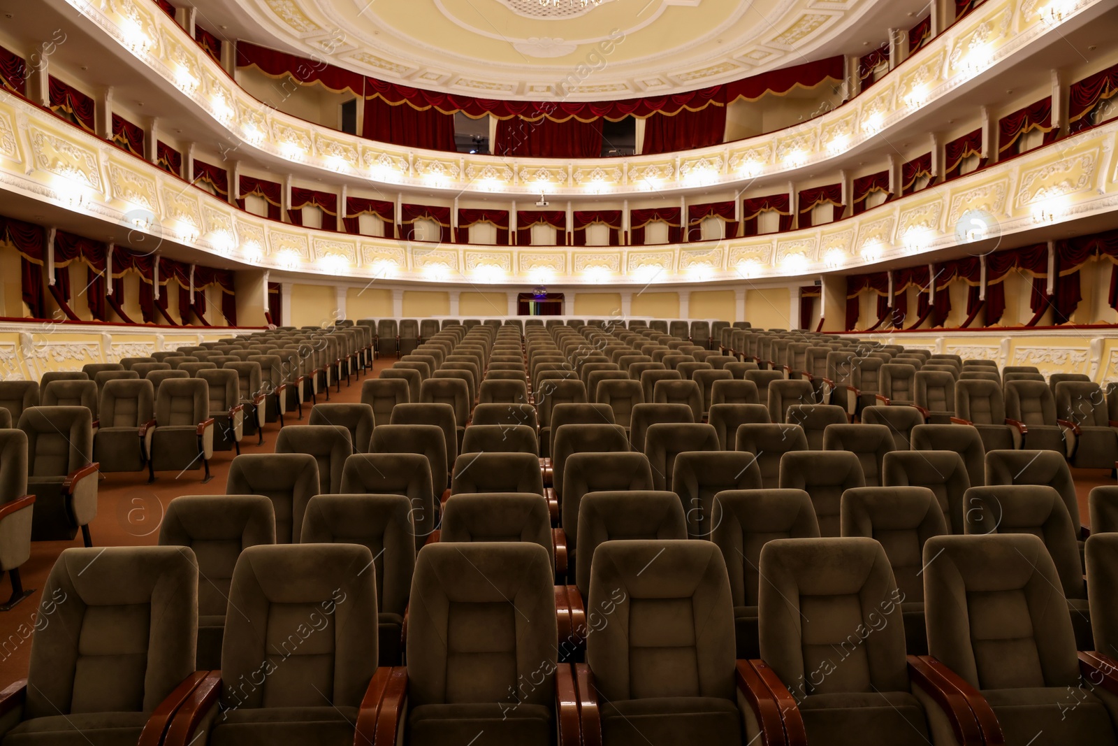 Photo of Rows of gray comfortable seats in theatre