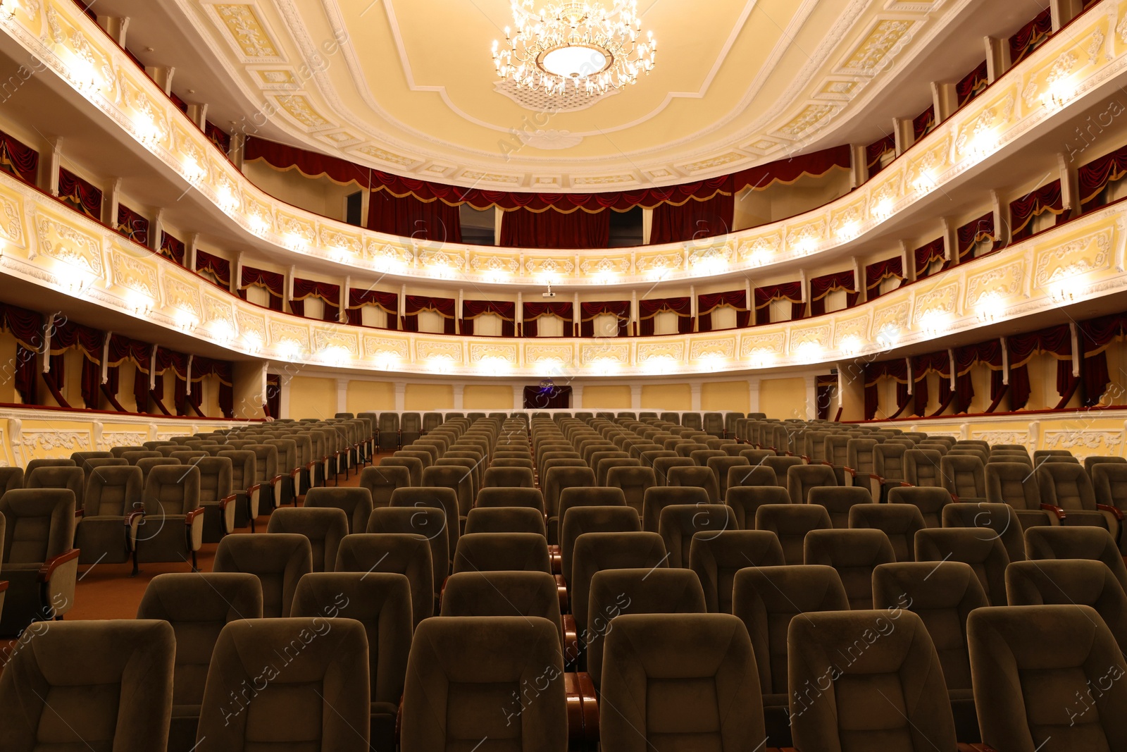 Photo of Rows of gray comfortable seats in theatre