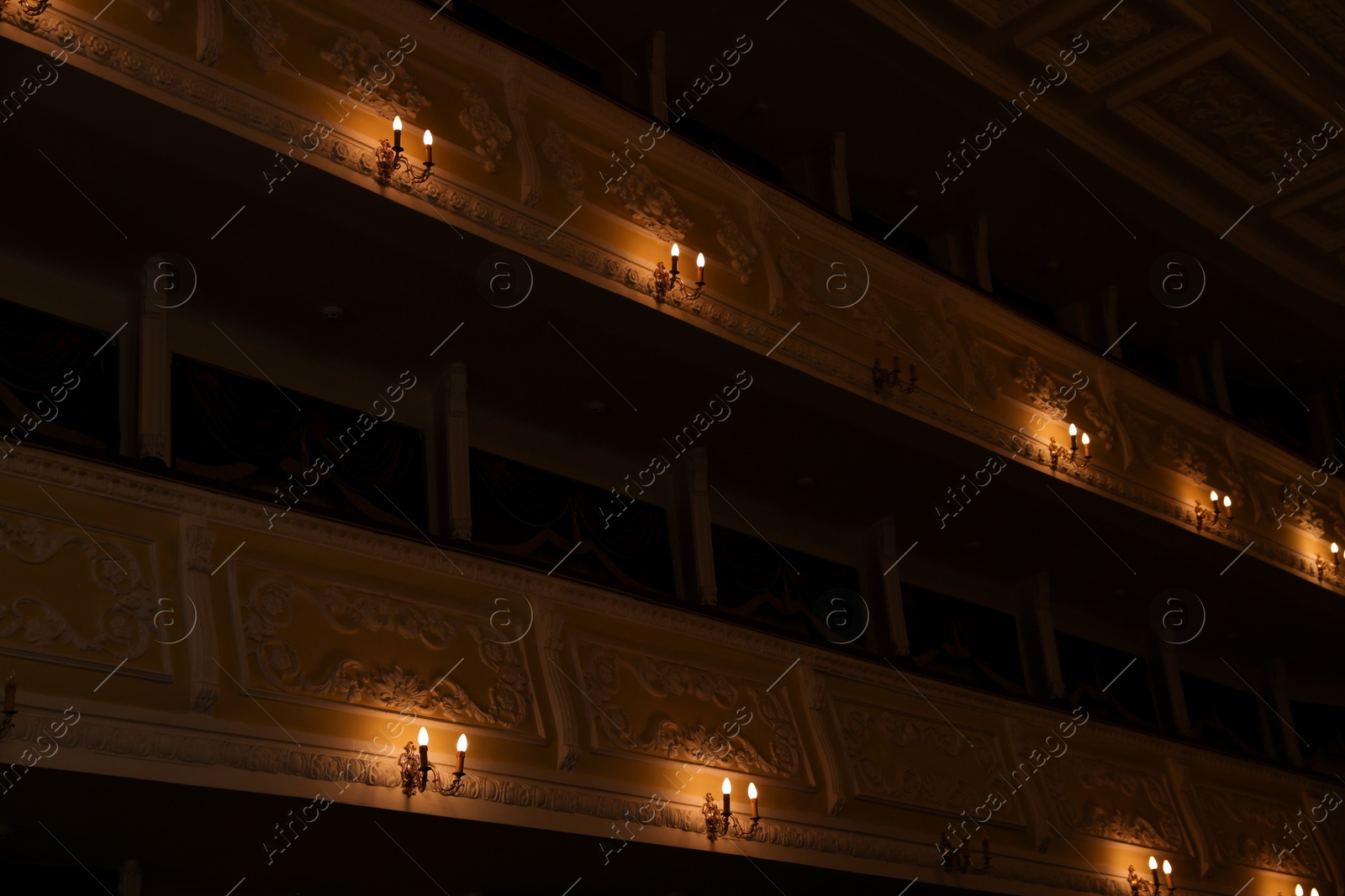 Photo of Vintage lamps on wall in theatre, low angle view