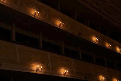 Photo of Vintage lamps on wall in theatre, low angle view