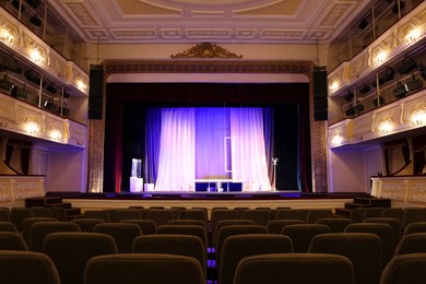 Photo of Theatre interior with stage and rows of comfortable seats