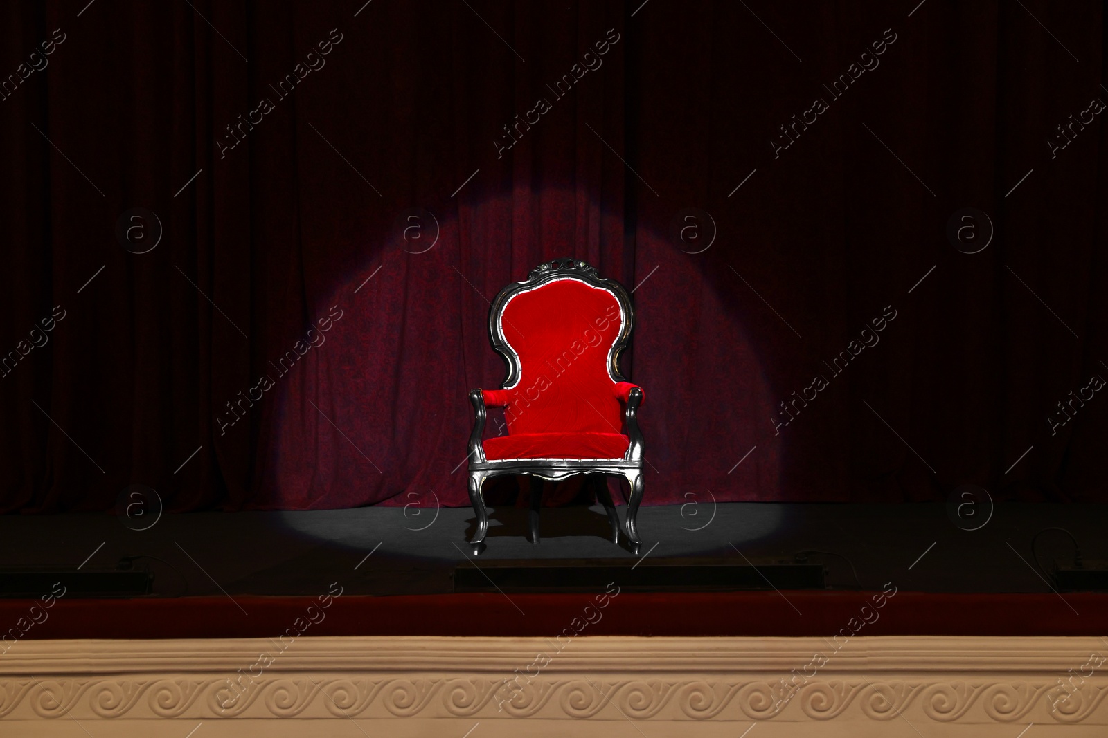 Photo of Vintage red armchair on stage in theatre