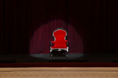 Photo of Vintage red armchair on stage in theatre