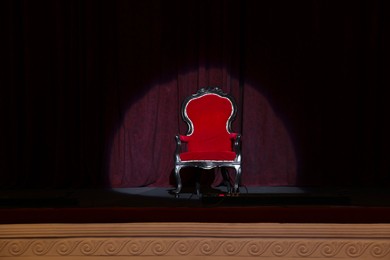 Photo of Vintage red armchair on stage in theatre