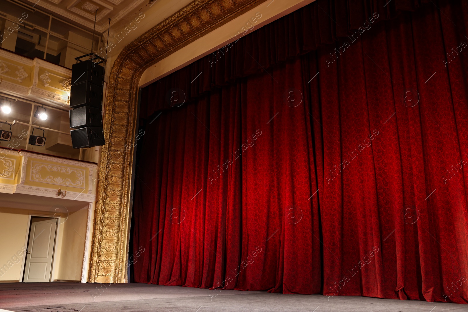 Photo of Elegant red curtains and spotlights in theatre