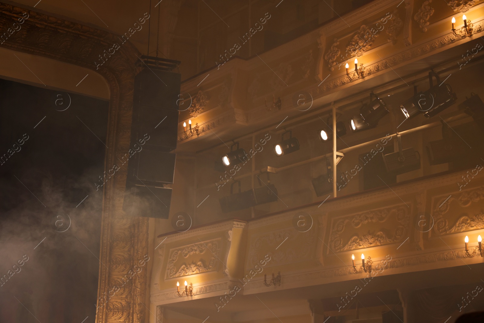 Photo of Professional spotlights and smoke in theatre, low angle view