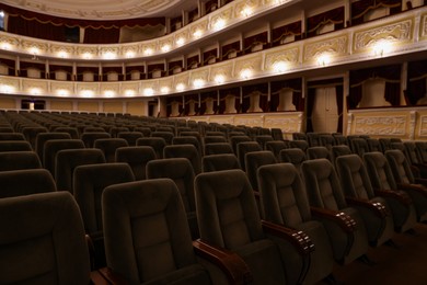 Photo of Rows of gray comfortable seats in theatre