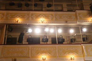 Photo of Balconies with vintage lamps and professional spotlights in theatre