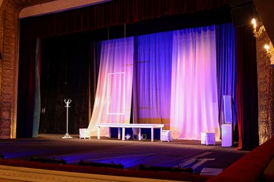 Photo of Different furniture and other decorations on stage in theatre