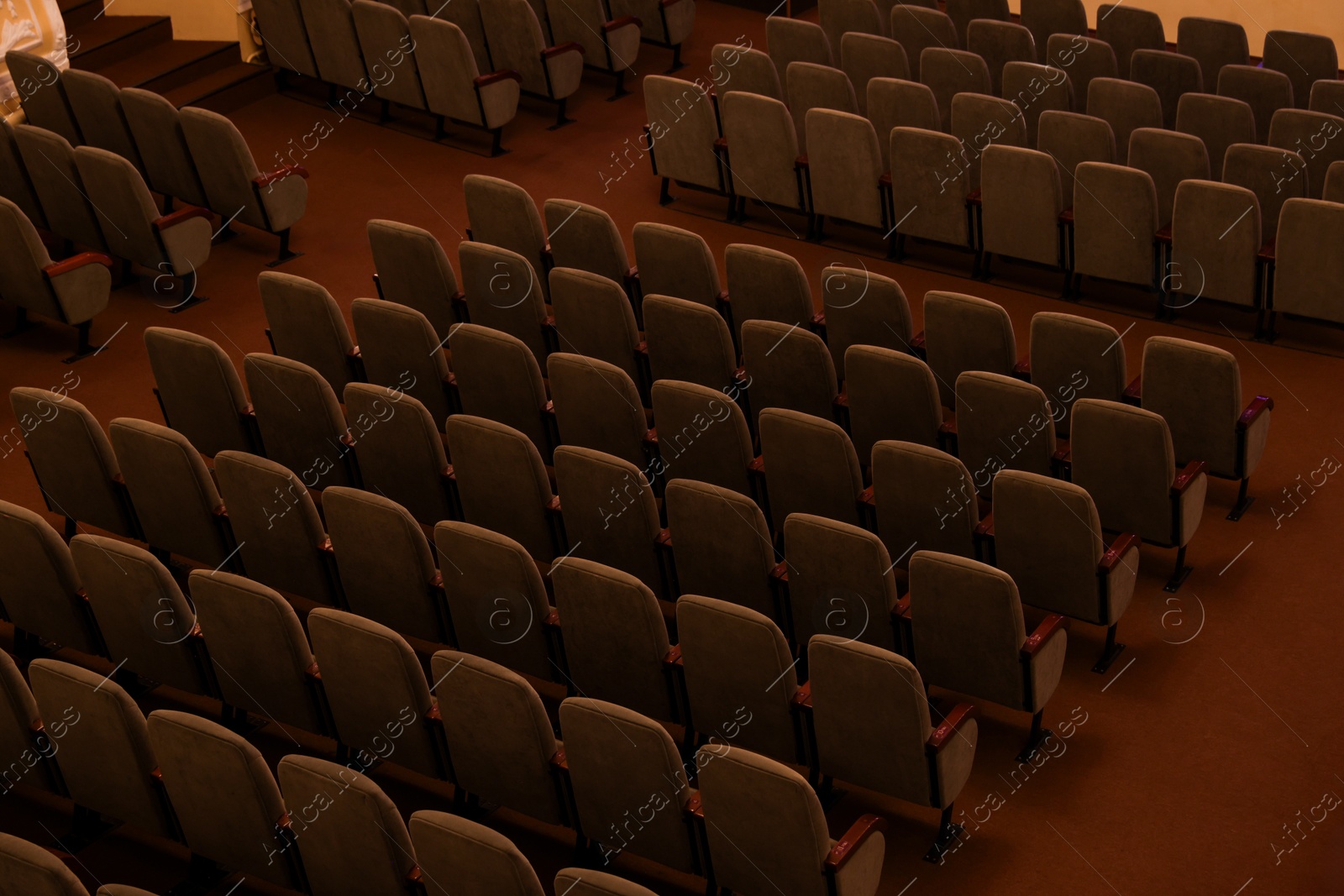 Photo of Rows of gray comfortable seats in theatre