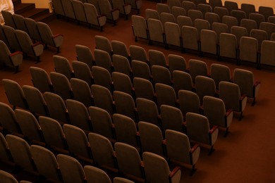 Photo of Rows of gray comfortable seats in theatre