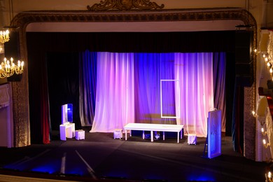 Photo of Different furniture and other decorations on stage in theatre