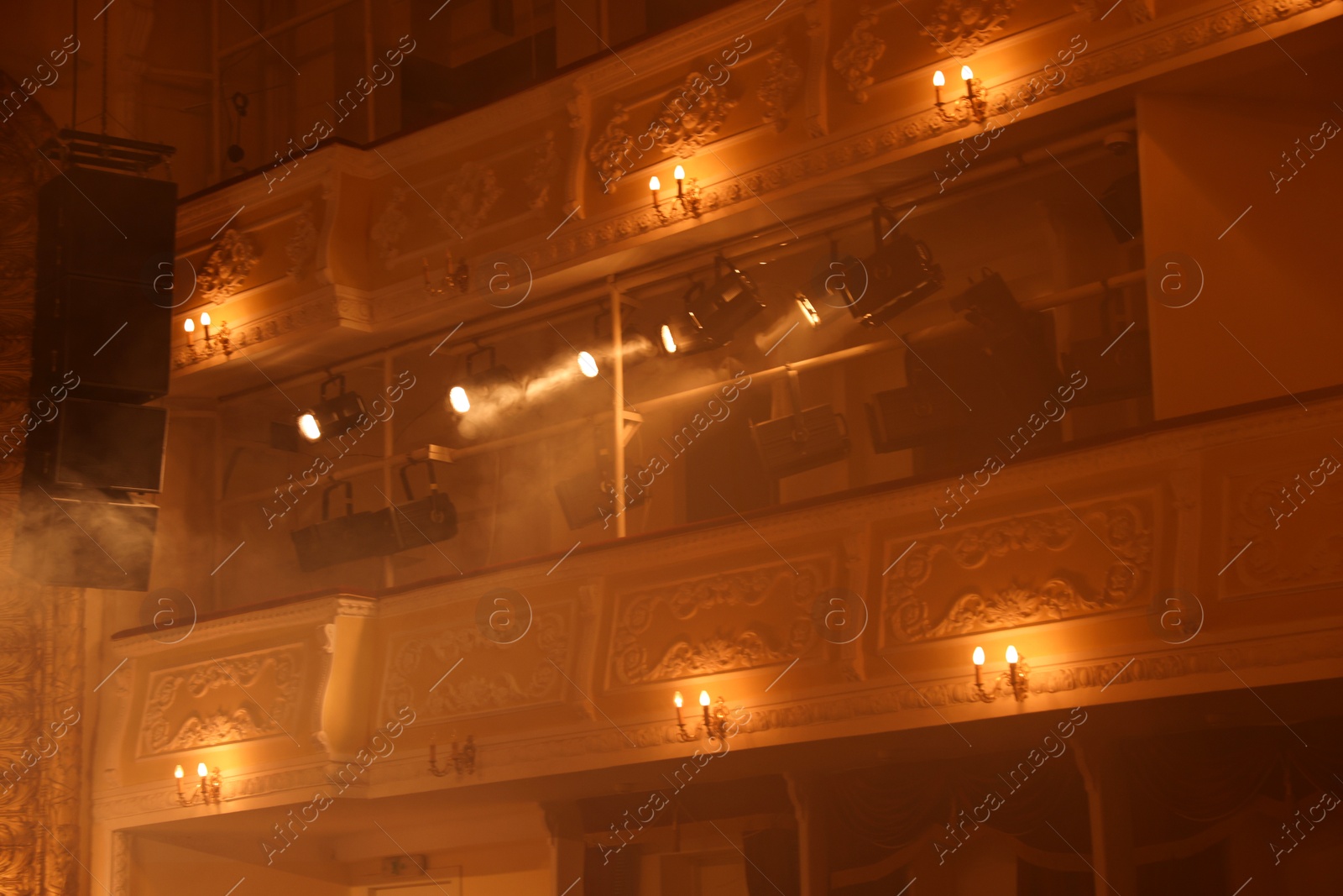 Photo of Professional spotlights and smoke in theatre, low angle view