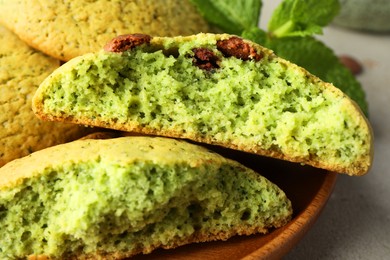 Photo of Delicious mint chocolate chip cookies on light table, closeup