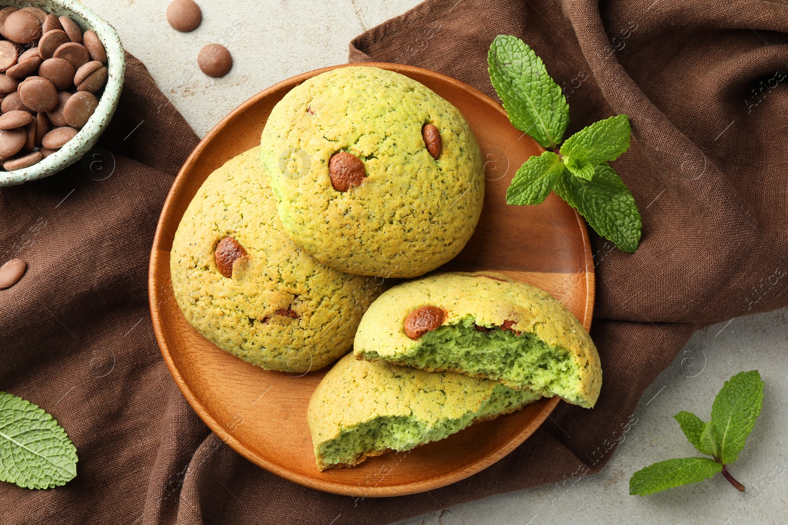 Photo of Delicious mint chocolate chip cookies on light table, flat lay