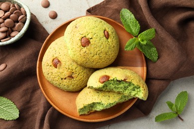 Photo of Delicious mint chocolate chip cookies on light table, flat lay