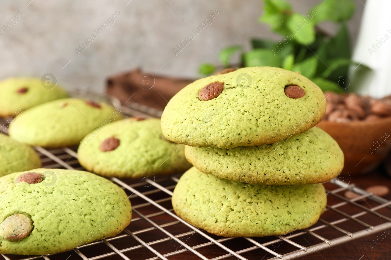 Photo of Delicious mint chocolate chip cookies on wooden table, closeup