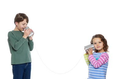 Boy and girl talking on tin can telephone against white background