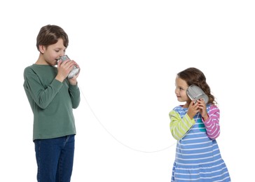 Photo of Boy and girl talking on tin can telephone against white background