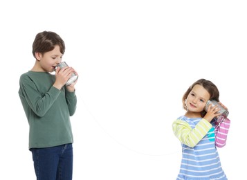 Photo of Boy and girl talking on tin can telephone against white background