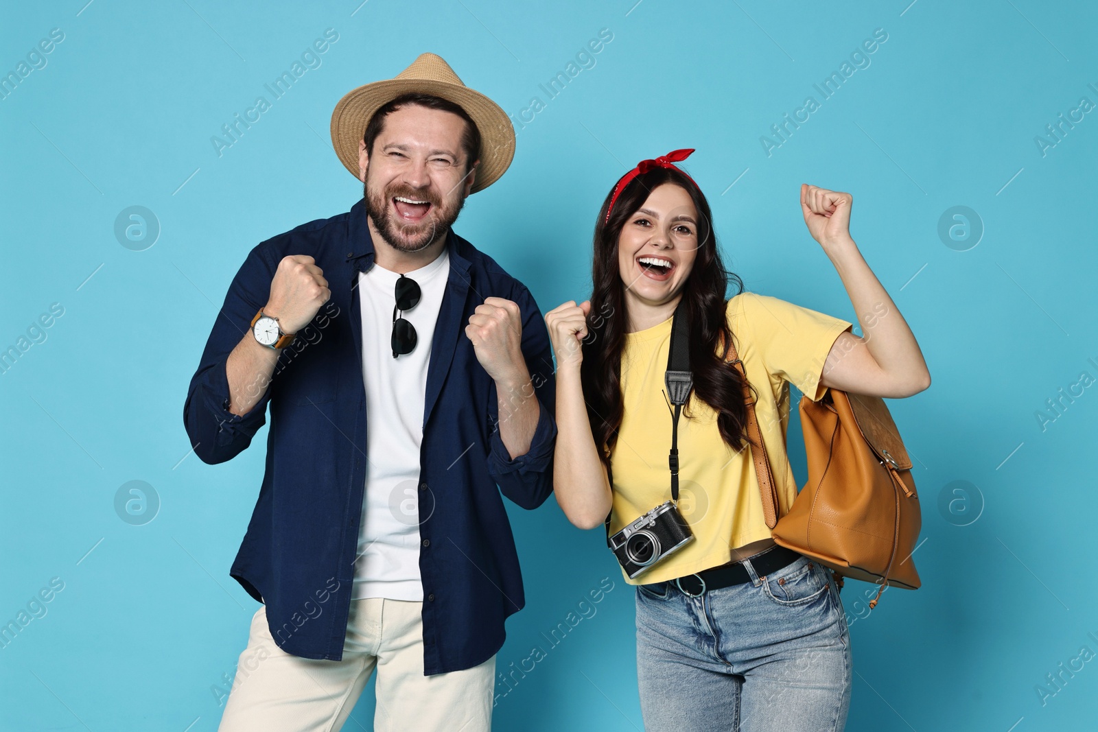 Photo of Tourism. Emotional couple on light blue background