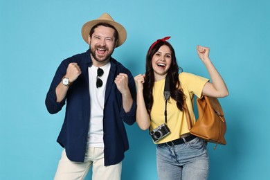 Tourism. Emotional couple on light blue background