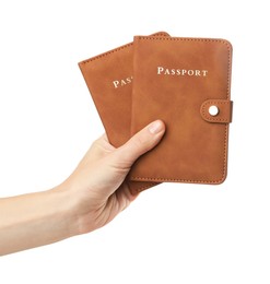 Photo of Woman holding passports in bright covers on white background, closeup