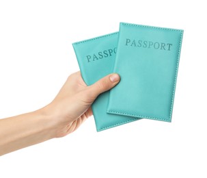 Photo of Woman holding passports in bright covers on white background, closeup