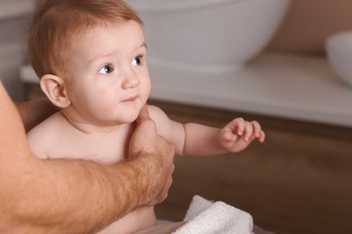 Man with his cute little baby indoors, closeup