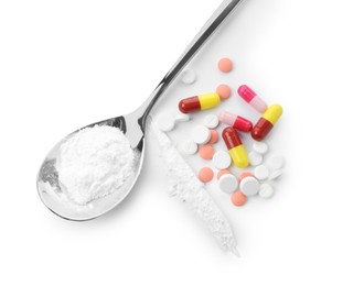 Photo of Drug addiction. Different pills and spoon with powder isolated on white, top view