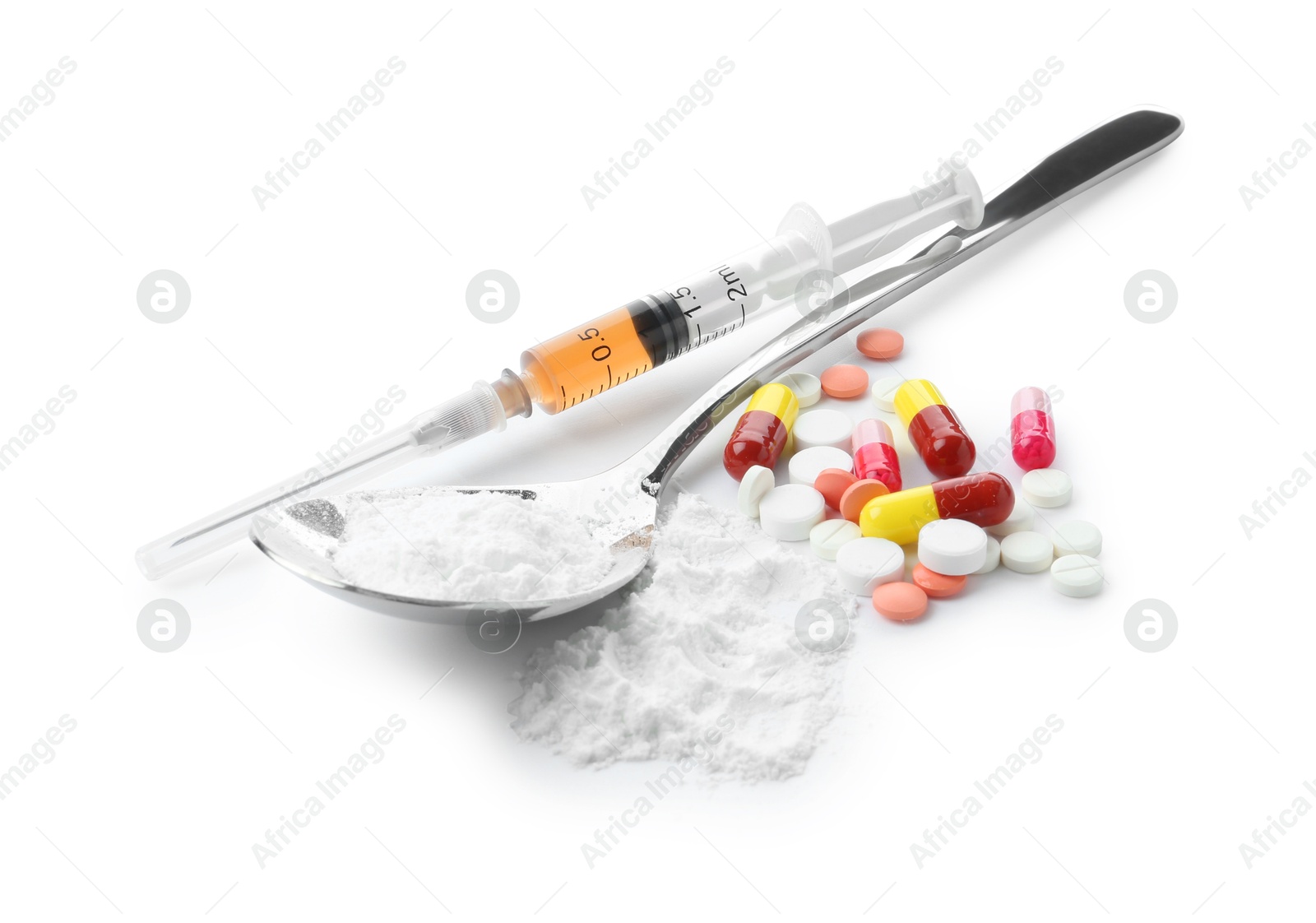 Photo of Drug addiction. Different pills, spoon with powder and syringe isolated on white