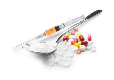 Photo of Drug addiction. Different pills, spoon with powder and syringe isolated on white