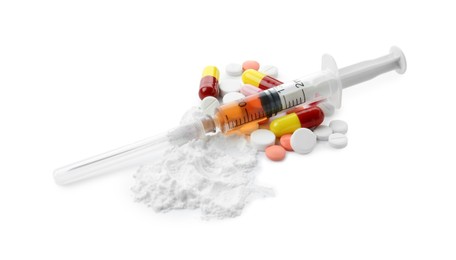 Photo of Drug addiction. Different pills, syringe and powder isolated on white