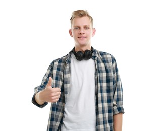 Photo of Happy man with headphones showing thumbs up on white background. Like gesture