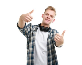 Photo of Happy man with headphones showing thumbs up on white background. Like gesture