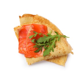 Photo of Delicious crepes with salmon and arugula isolated on white, top view