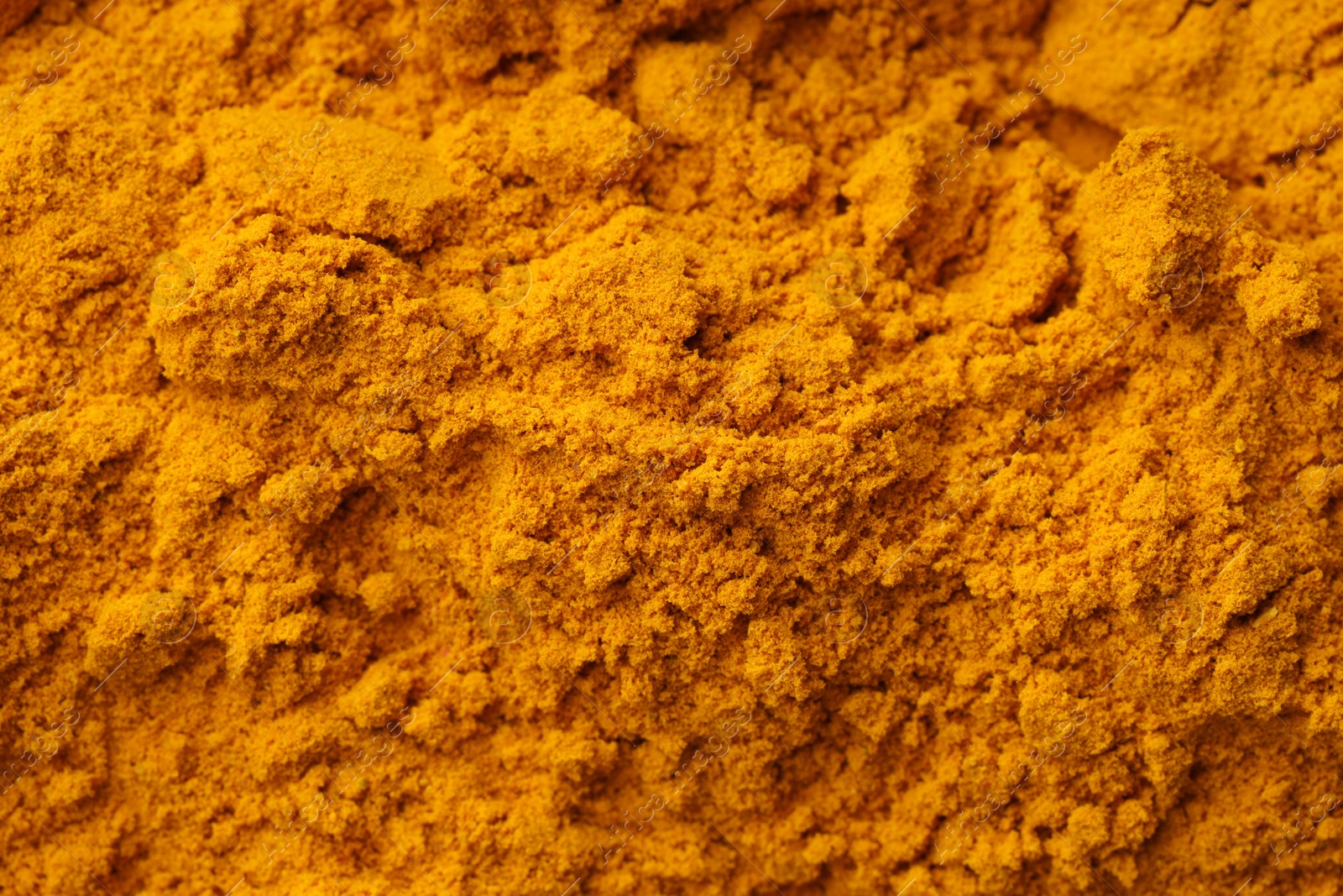 Photo of Aromatic turmeric powder as background, top view