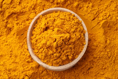 Photo of Turmeric powder in bowl on spice, top view